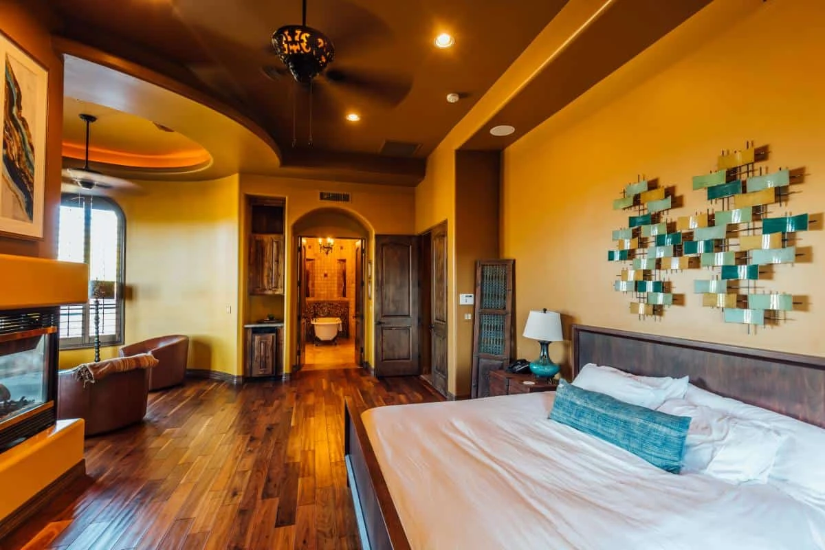 Private bedroom with hardwood floors and warm lighting