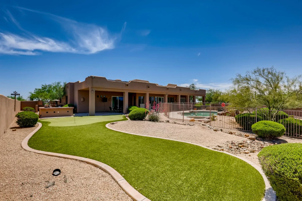 Manicured backyard lawn behind the residence