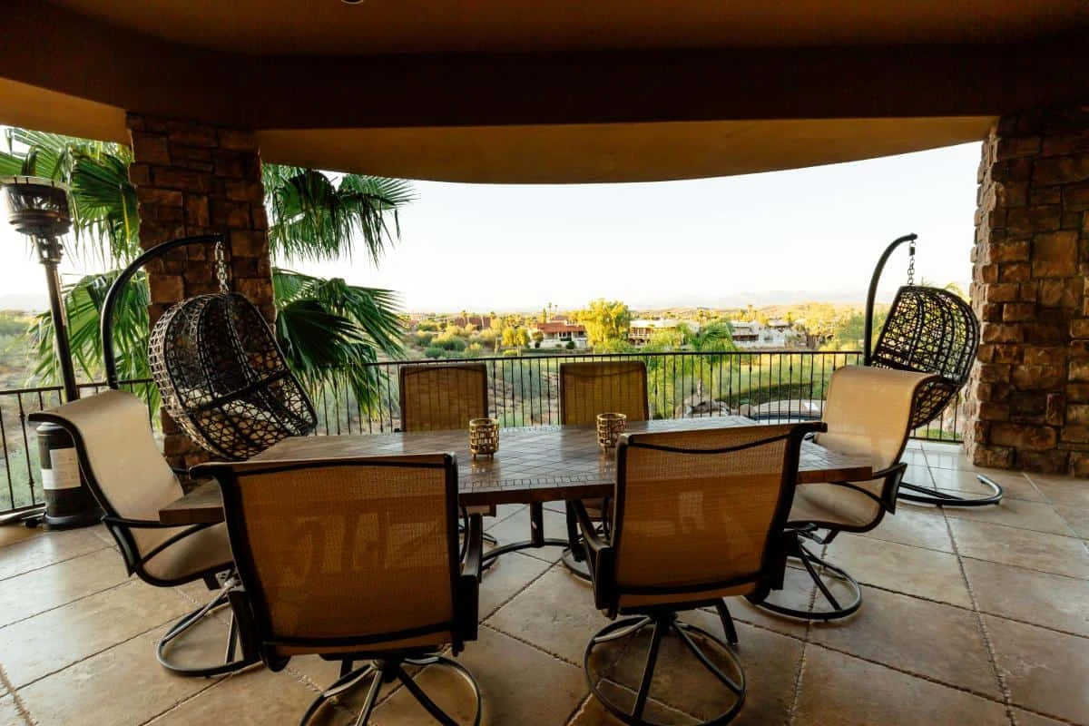 Shaded outdoor dining terrace with desert and palm views
